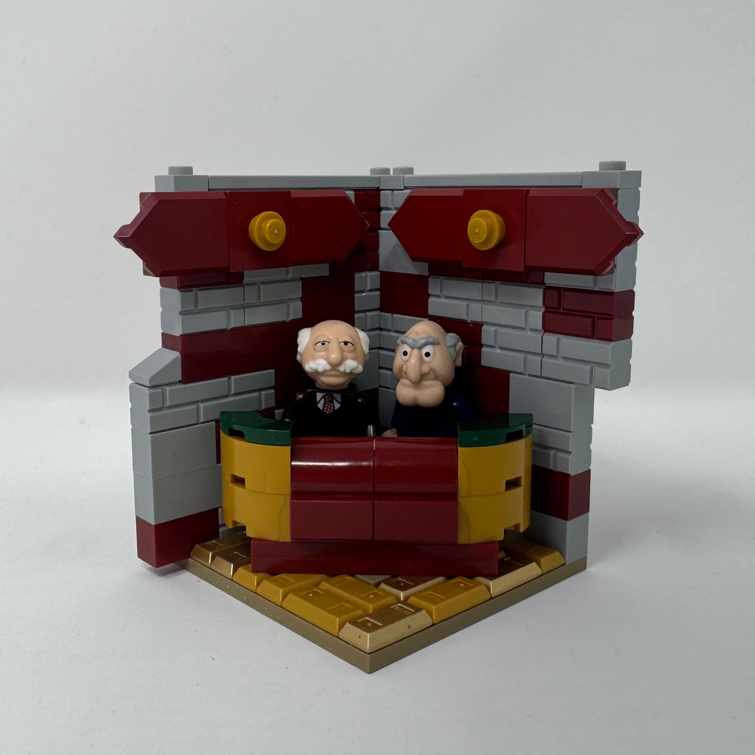 Small model of a building with a figure on a white background